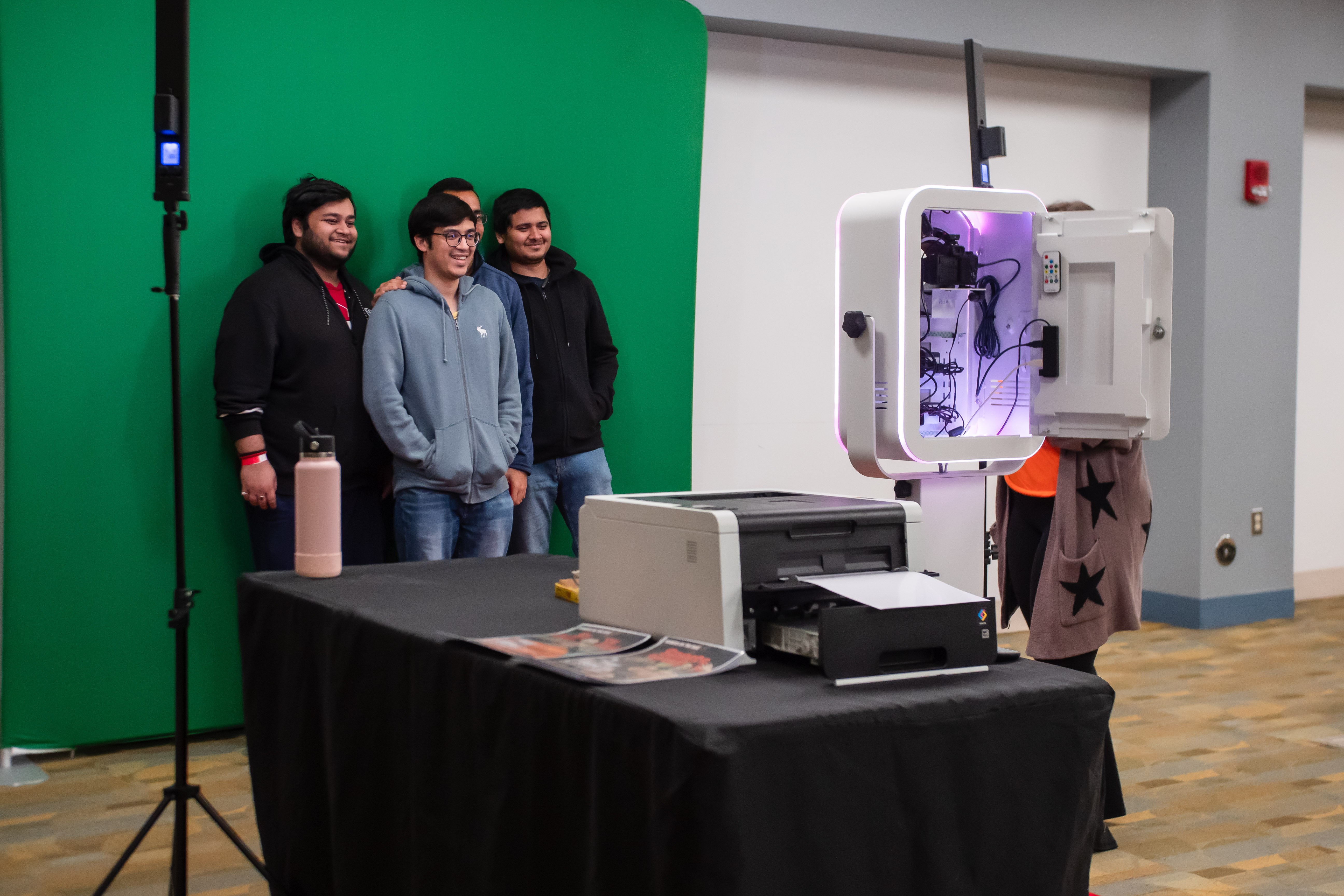 Students taking a picture at Late Knight photobooth